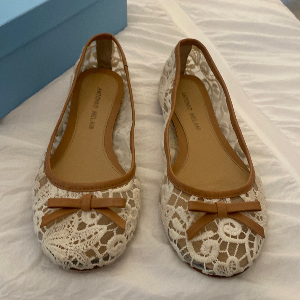 Beautiful lace with nude accents flat shoes.